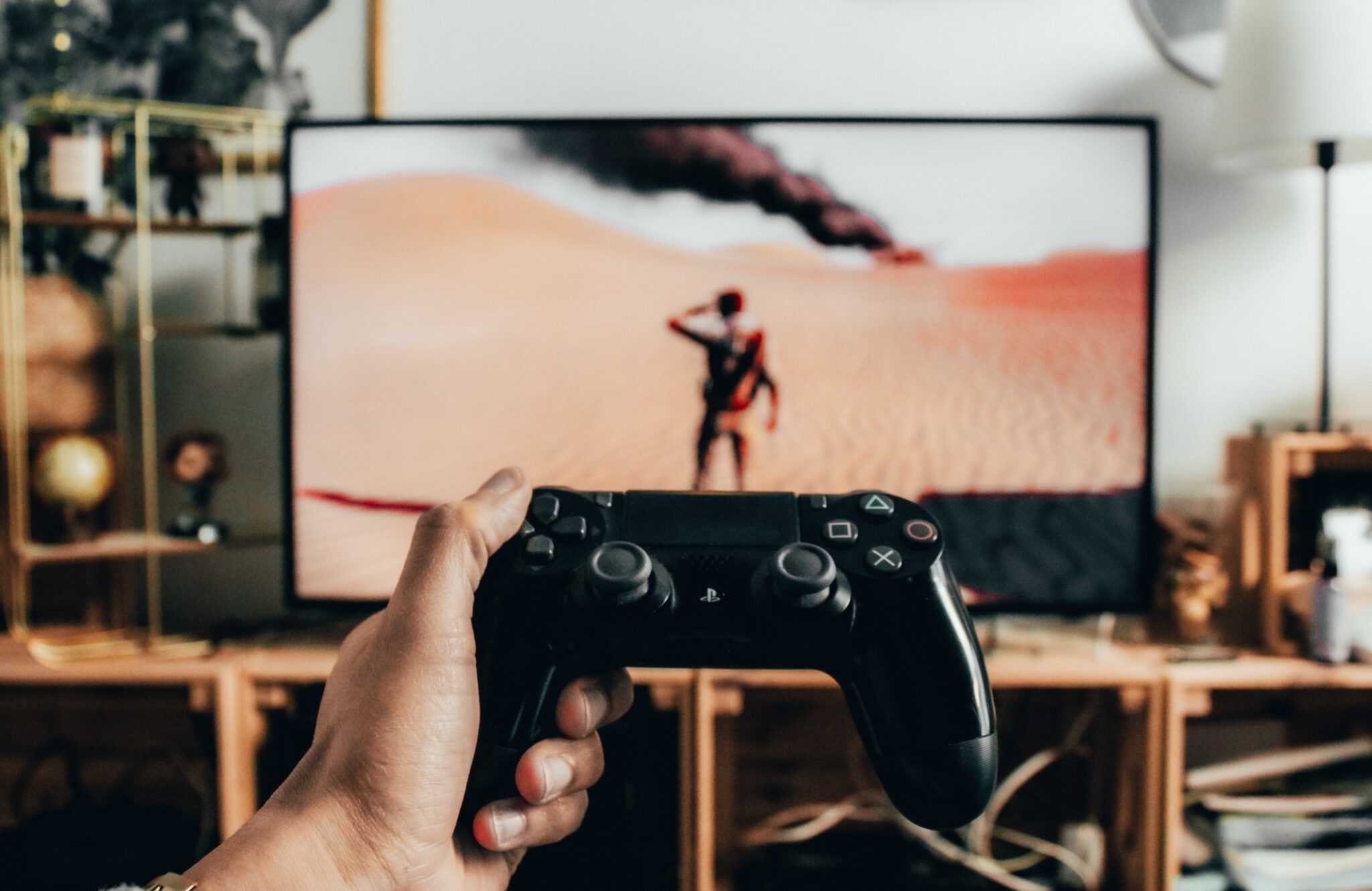 A hand holding a Playstation controller and playing Mad Max.

Video game localisation is an important part of the industry